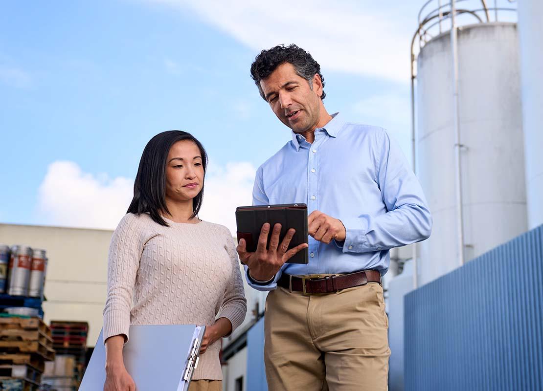 Man and woman reviewing tablet and information together zscaler-and-servicenow