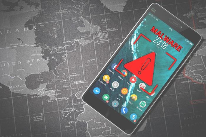Technical Analysis of Anatsa Campaigns: An Android Banking Malware Active in the Google Play Store A mobile phone against a map of the world. The mobile phone has a red malware alert.