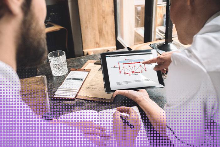 Two people collaborating in an office Two people collaborating in an office