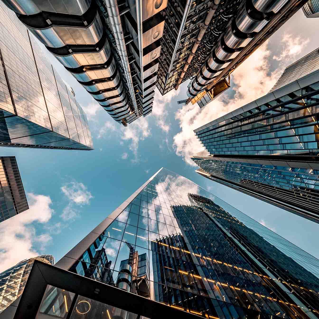 looking up toward the sky surrounded by skyrises