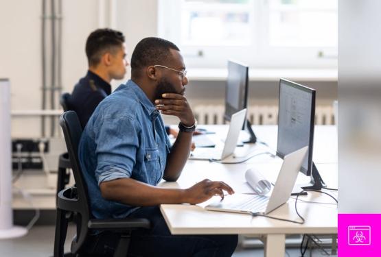 A man seated at a desk, focusing on the critical aspects of new ransomware types