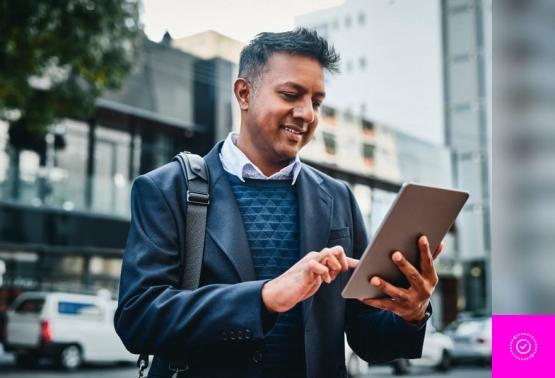 A professional using a tablet for business, showcasing tips for secure remote access and effective productivity strategies.