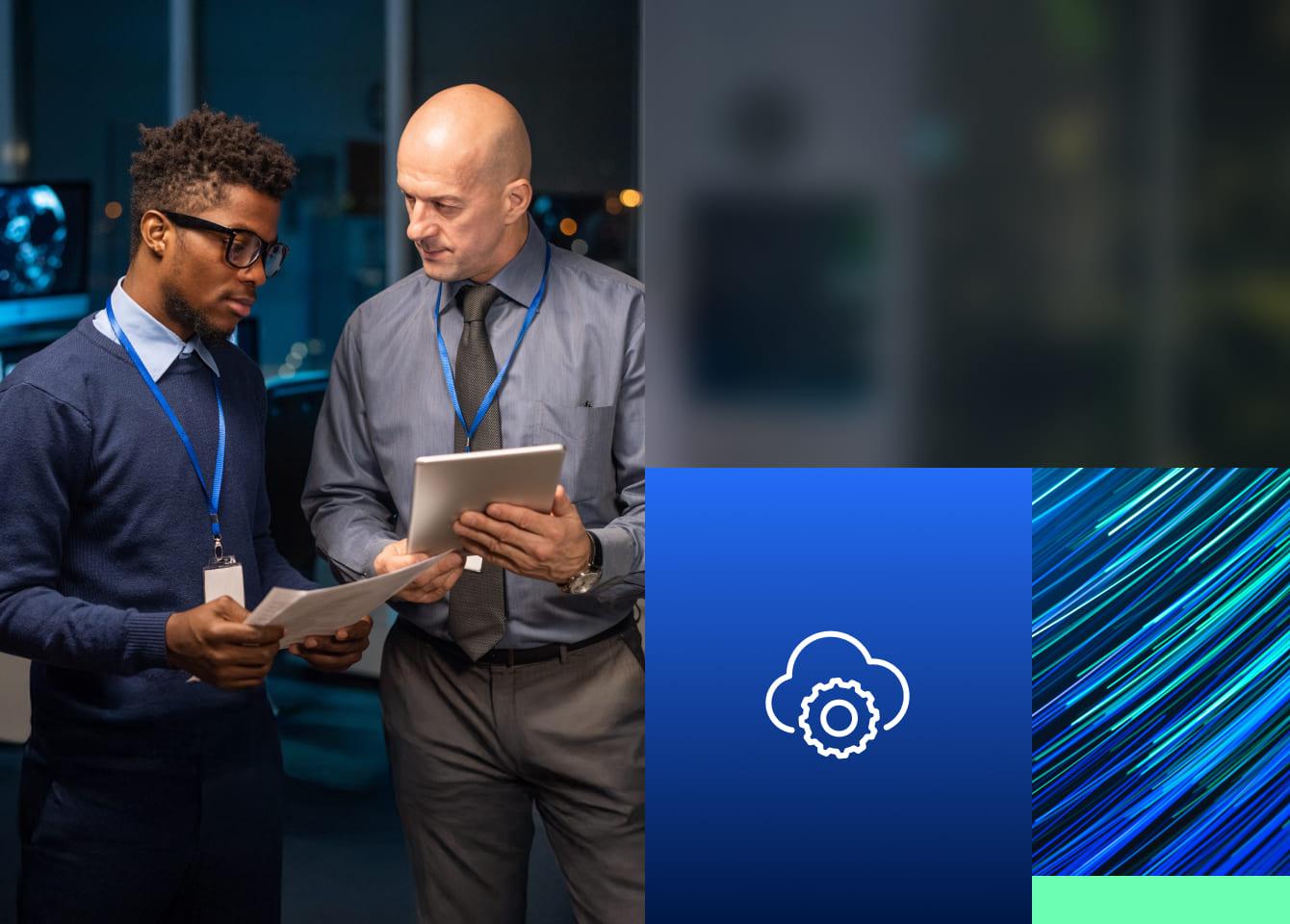 Two men in suits stand side by side, holding a tablet, symbolizing collaboration in threat exposure management.