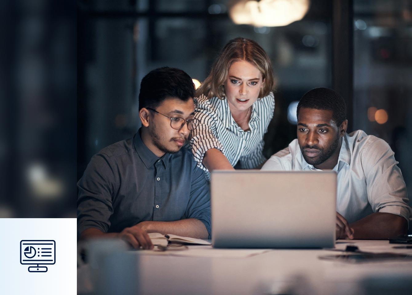 Three individuals engaged in a discussion while viewing a laptop in a meeting room, focusing on Zscaler Data Fabric for Security.