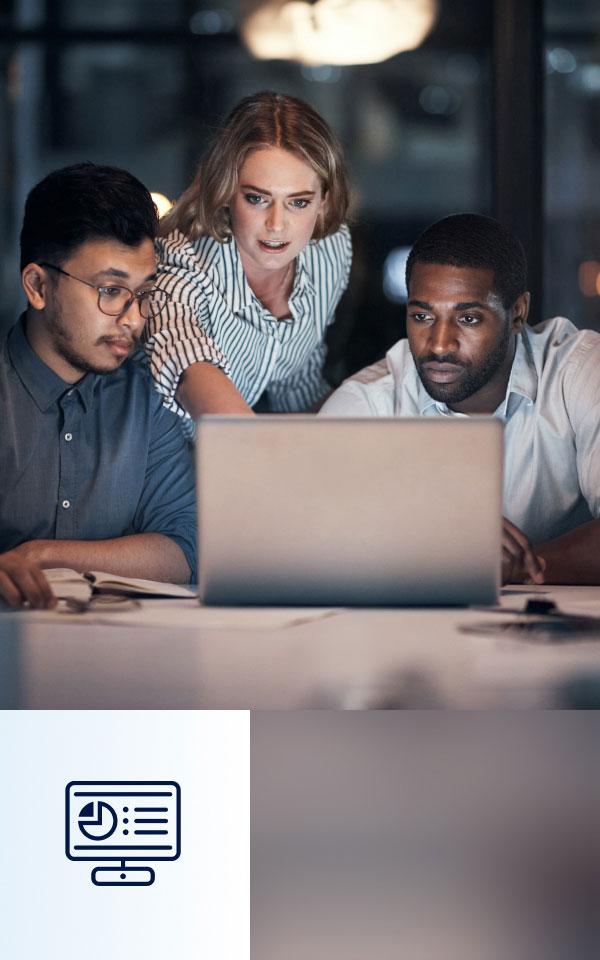 Three individuals engaged in a discussion while viewing a laptop in a meeting room, focusing on Zscaler Data Fabric for Security.