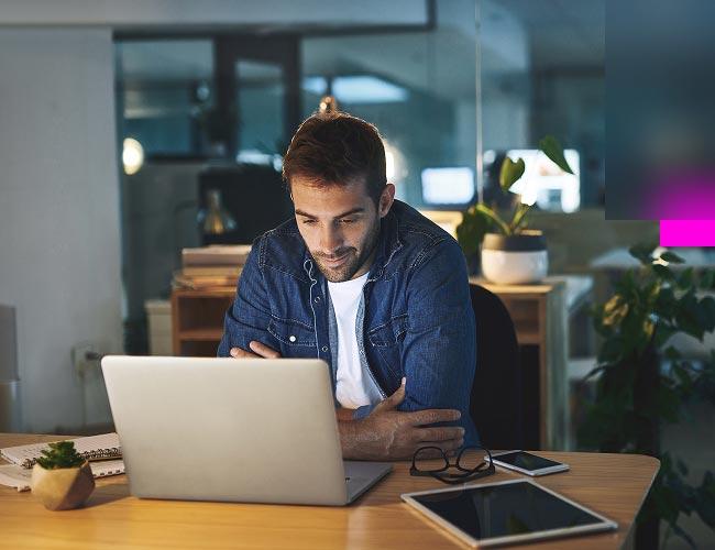 A man sitting at a laptop studying data security