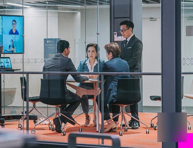 A group of business professionals discussing their needs for data security