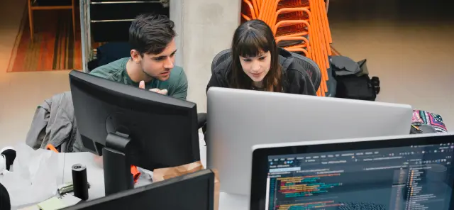 Man and woman working together on a computer