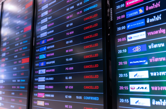 Airport flight status board showing canceled flights